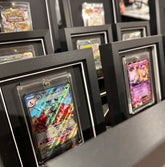Collection of framed trading cards on a shelf